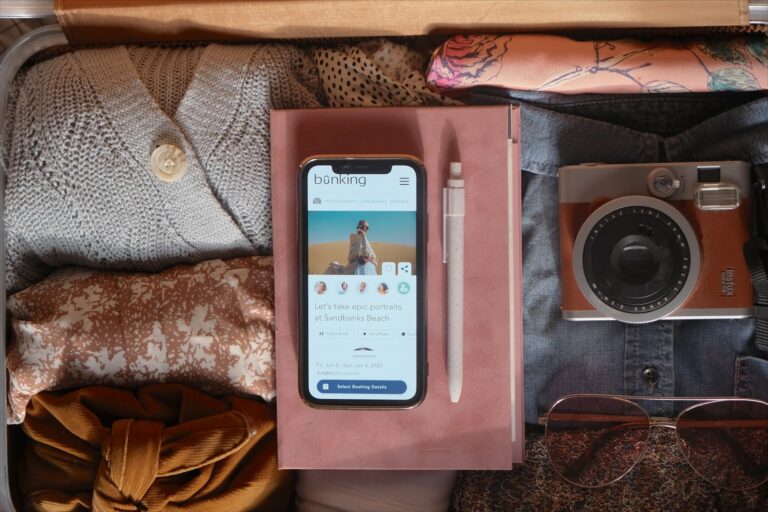 an open suitcase with a cell phone and other items